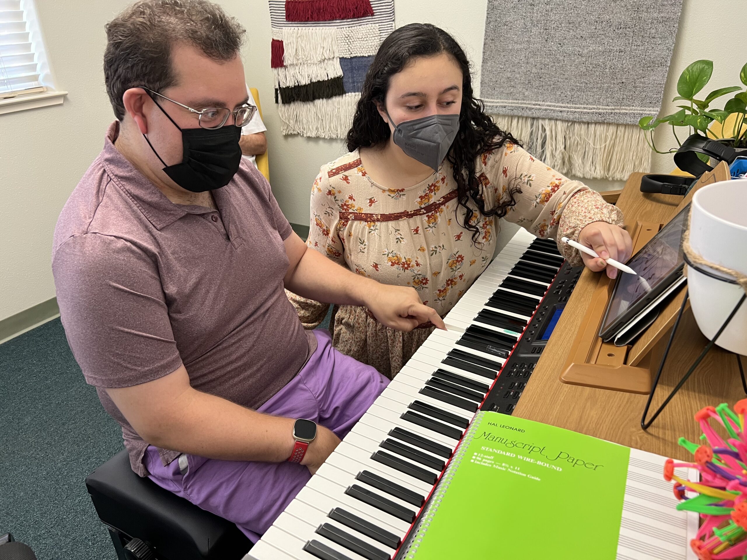 Lexi providing music therapy using a piano